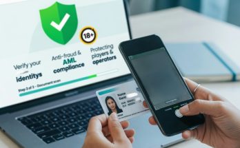 Hands scan an ID with a smartphone in front of a laptop showing an