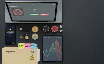 Flat-lay photo on a dark desk showing a laptop with an online-casino dashboard, a
